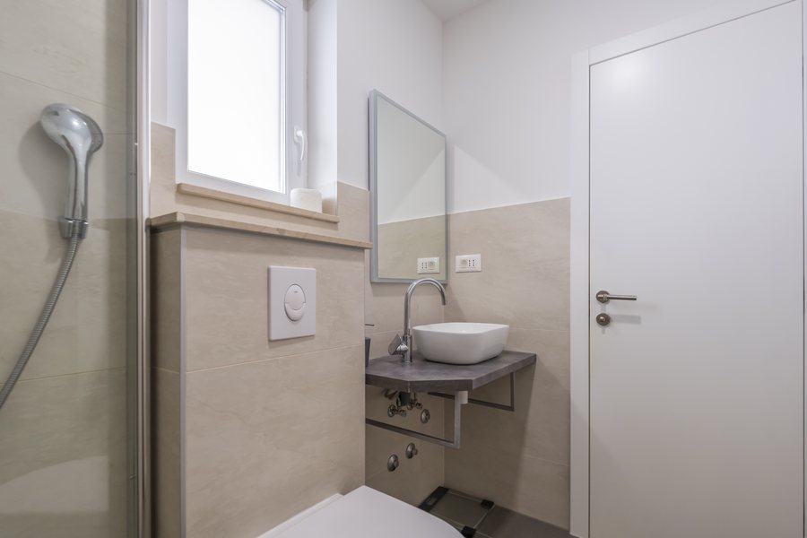 The bathroom on the same floor as the second kitchen