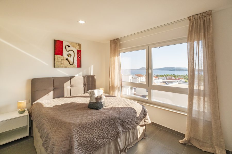 The double bed in bedroom 1, by the window