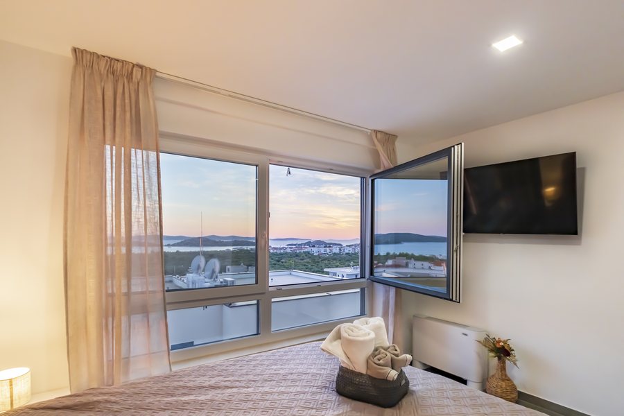 Bedroom 1 at sunset, with the television on the wall