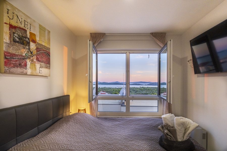 Bedroom 2 with the windows open at sunset