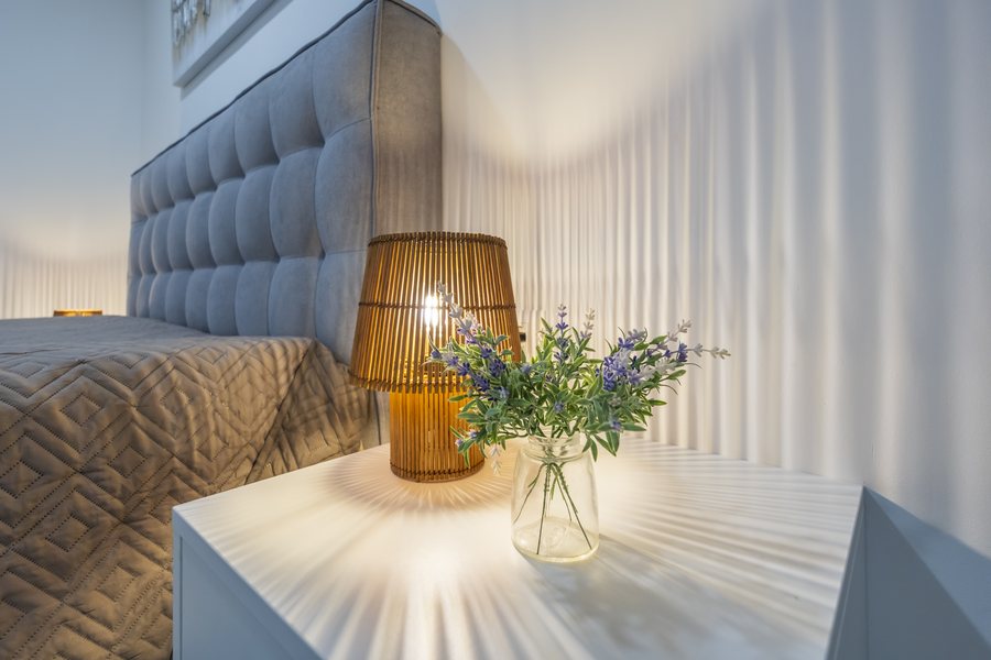A bedside lamp and flowers in bedroom 4