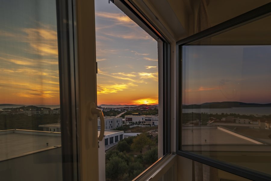 Sunset over the coast through the window of bedroom 1