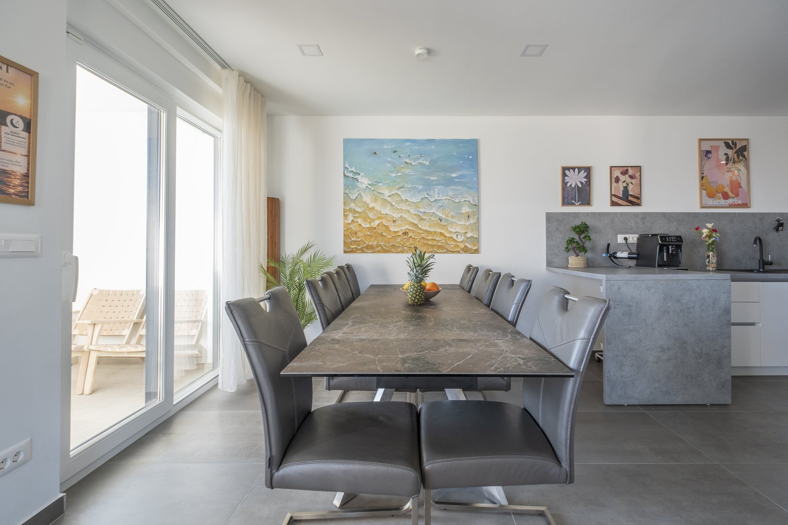 The long dining table, with the kitchen behind it