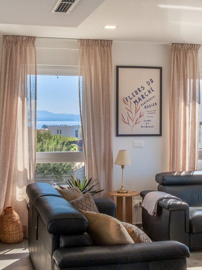 A corner of the living room, with the sea through the window