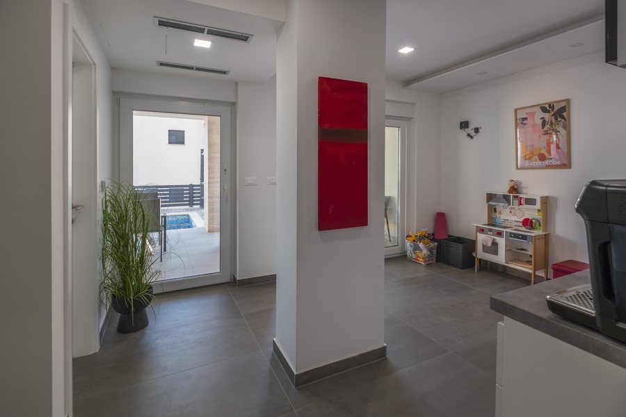 The hallway by the second kitchen, with a door to the outside