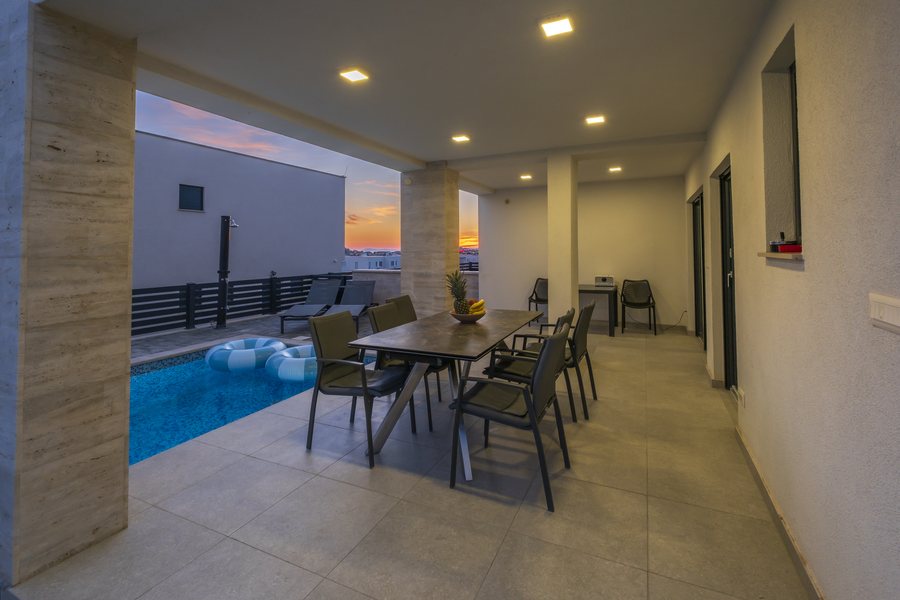 The covered dining area at dusk