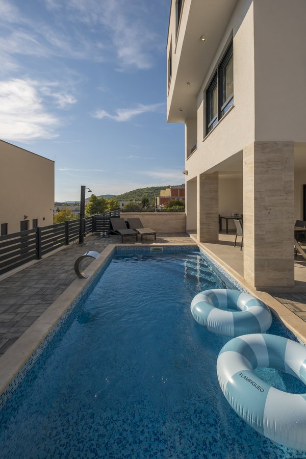 The pool beside the house, with pool rings