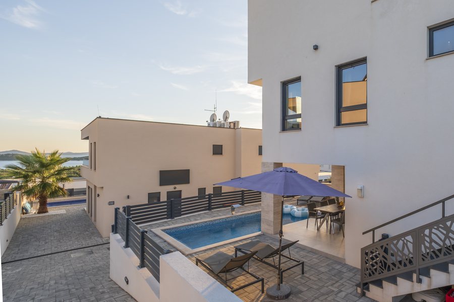 The pool with parasol and loungers, seen from above