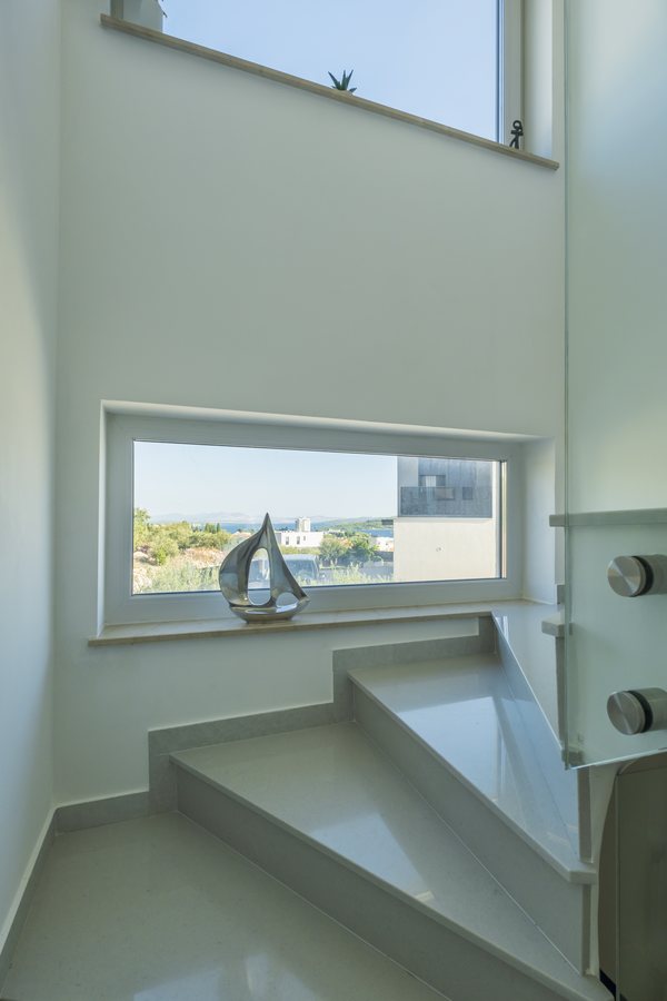 The staircase landing with a window and a model sailboat