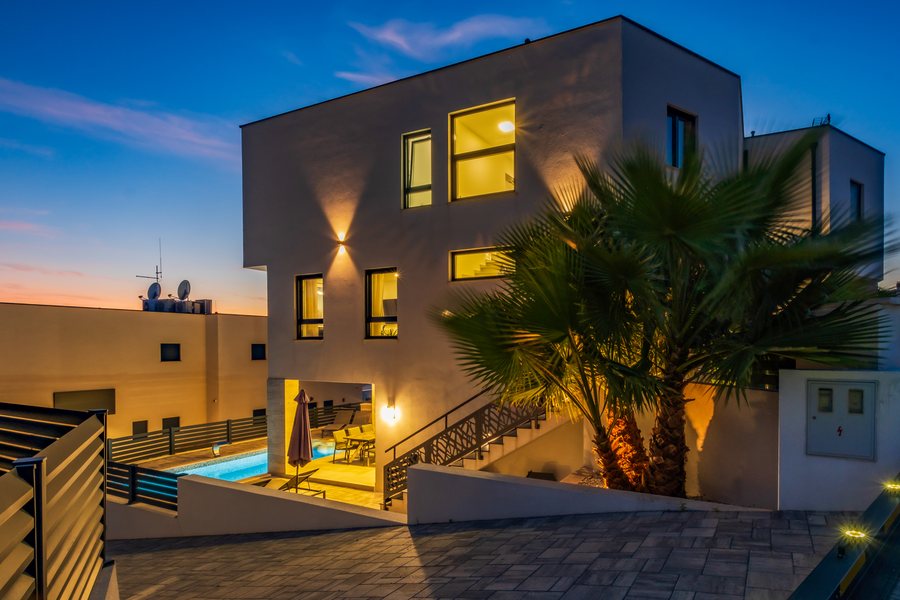 Villa NeRu at dusk, with the lights on
