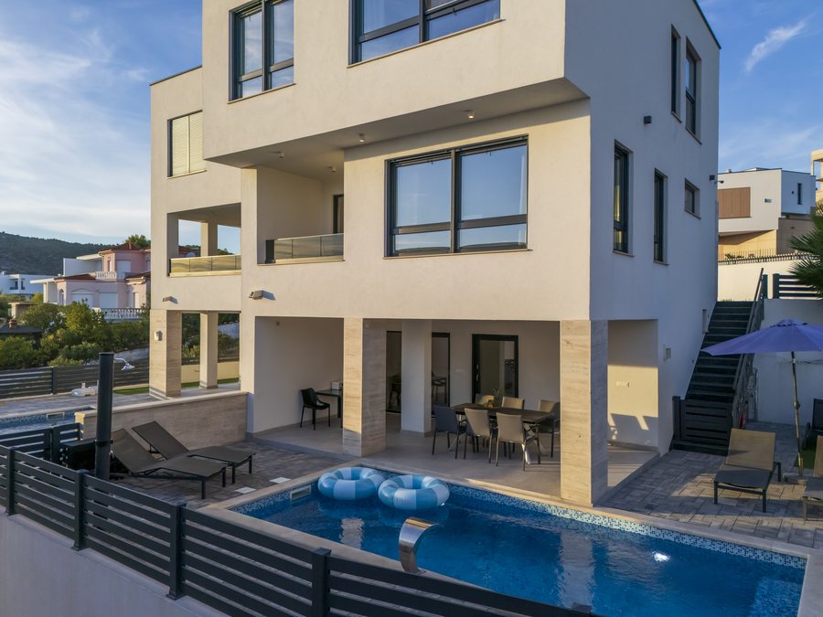 The villa and the pool from above, with the terrace under the house