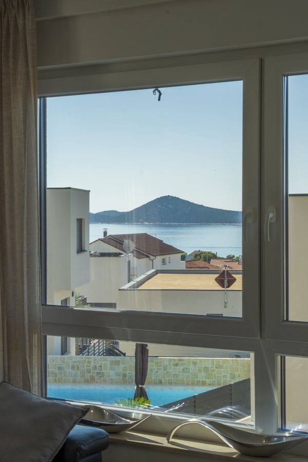 The sea and an island through the window, the pool below